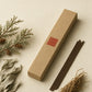 Quiet Page focus incense box with a single stick, ivory background