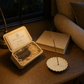 Quiet Page incense box with scent label open beside a book under a warm reading lamp at night