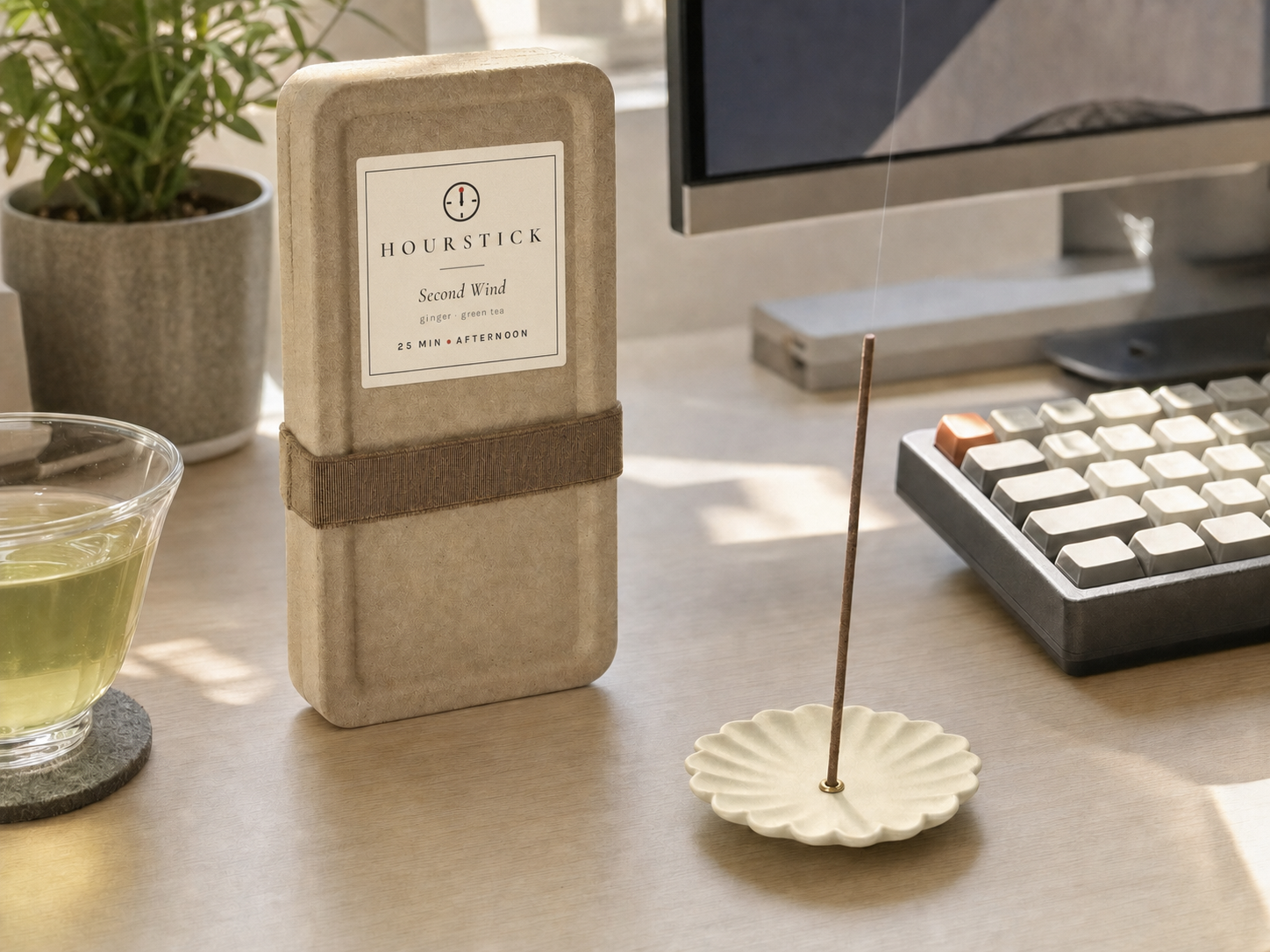 Second Wind incense box with scent label standing on an afternoon work desk with keyboard and green tea